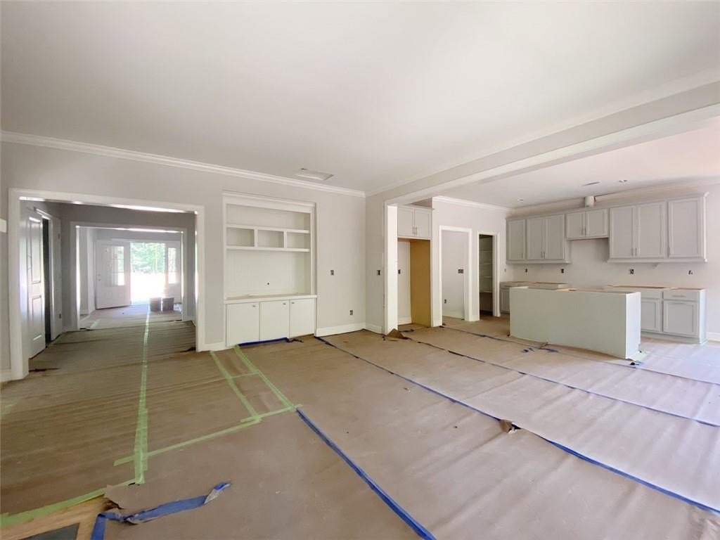 7584 Cypress Drive Graham, NC 27253 - Photo 4 of 18 a view of empty room with kitchen and window
