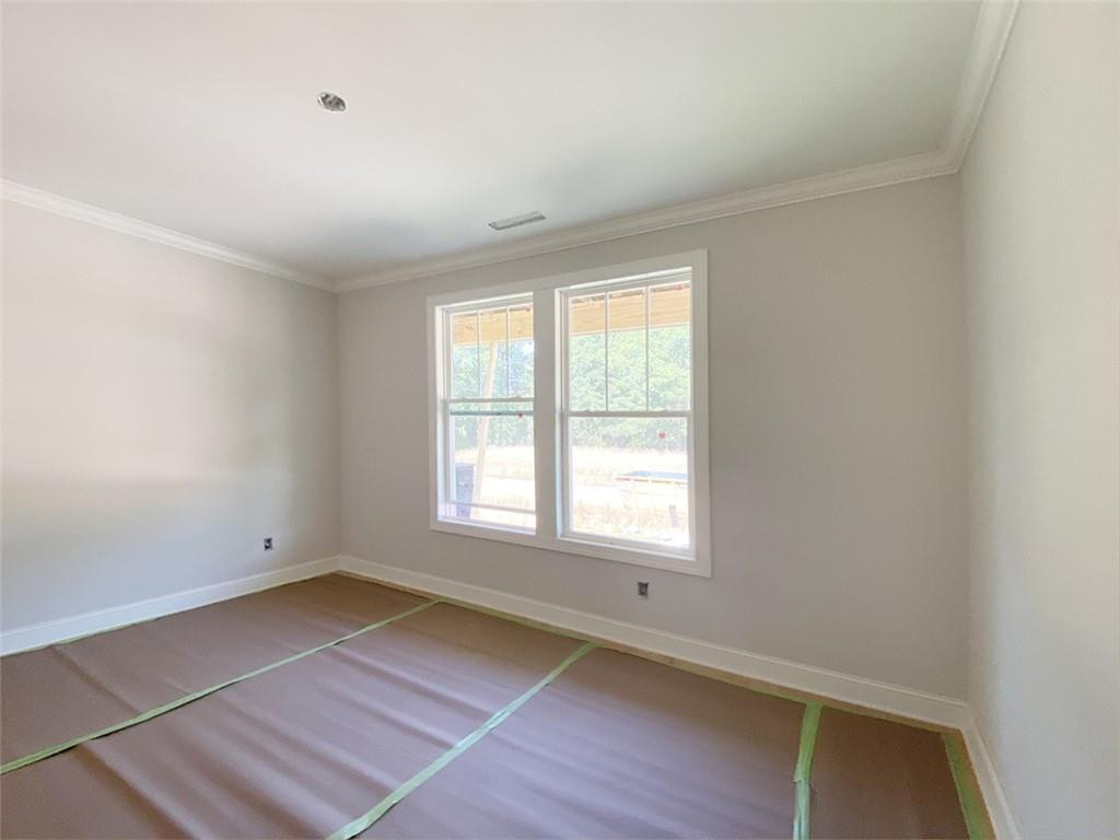 7584 Cypress Drive Graham, NC 27253 - Photo 6 of 18 an empty room with wooden floor and windows
