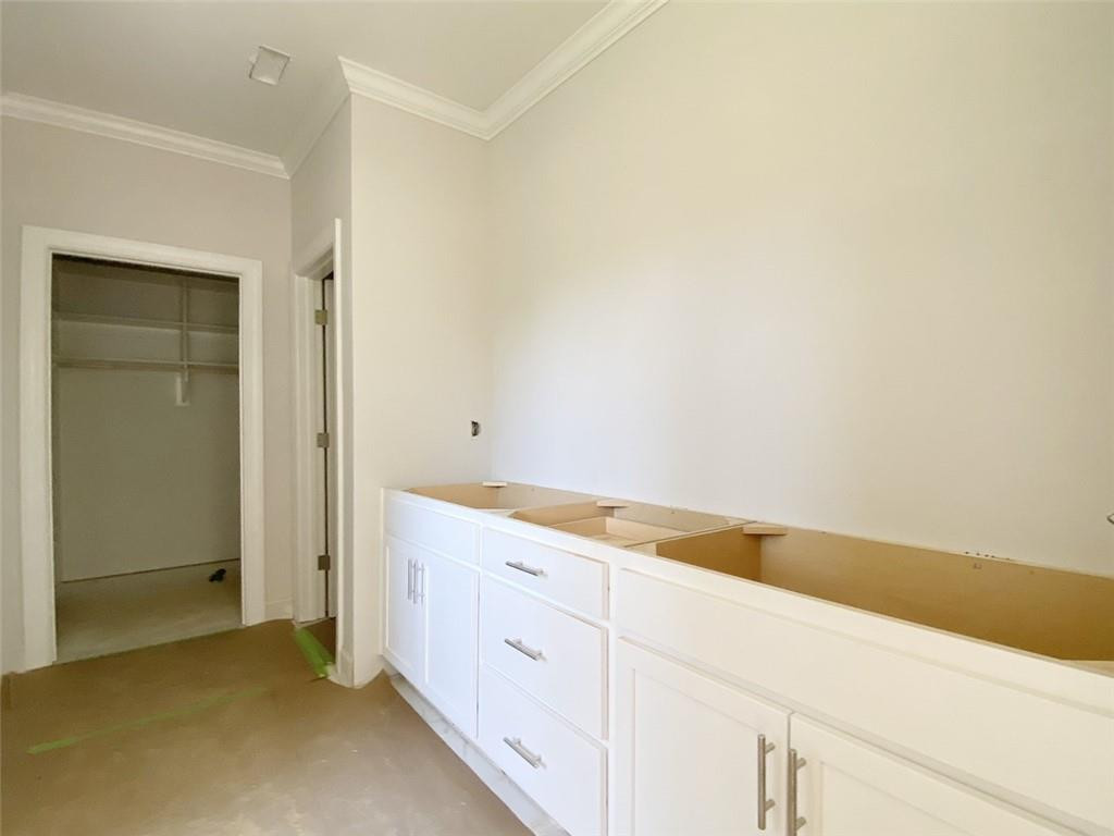 7584 Cypress Drive Graham, NC 27253 - Photo 9 of 18 a view of cabinets and utility room