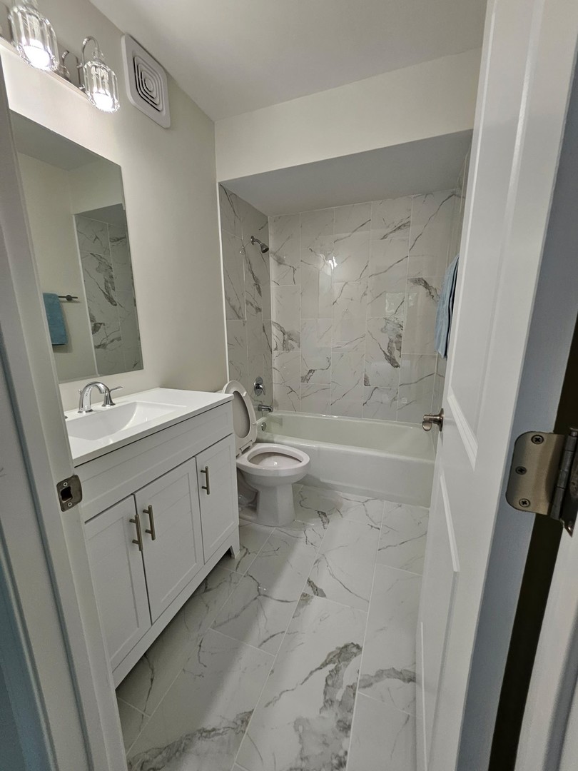 14969 South Willowcrest Drive, Unit 17 Midlothian, IL 60445 - Photo 11 of 12 a bathroom with a double vanity sink mirror and toilet