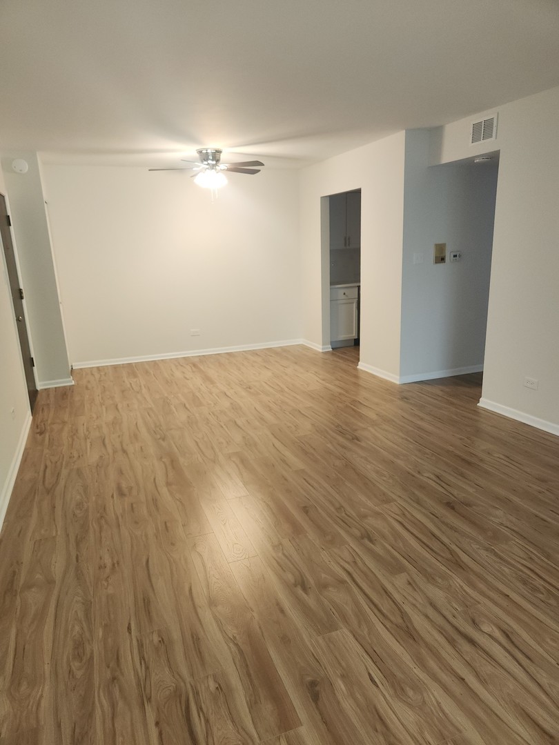 14969 South Willowcrest Drive, Unit 17 Midlothian, IL 60445 - Photo 8 of 12 a view of empty room with wooden floor