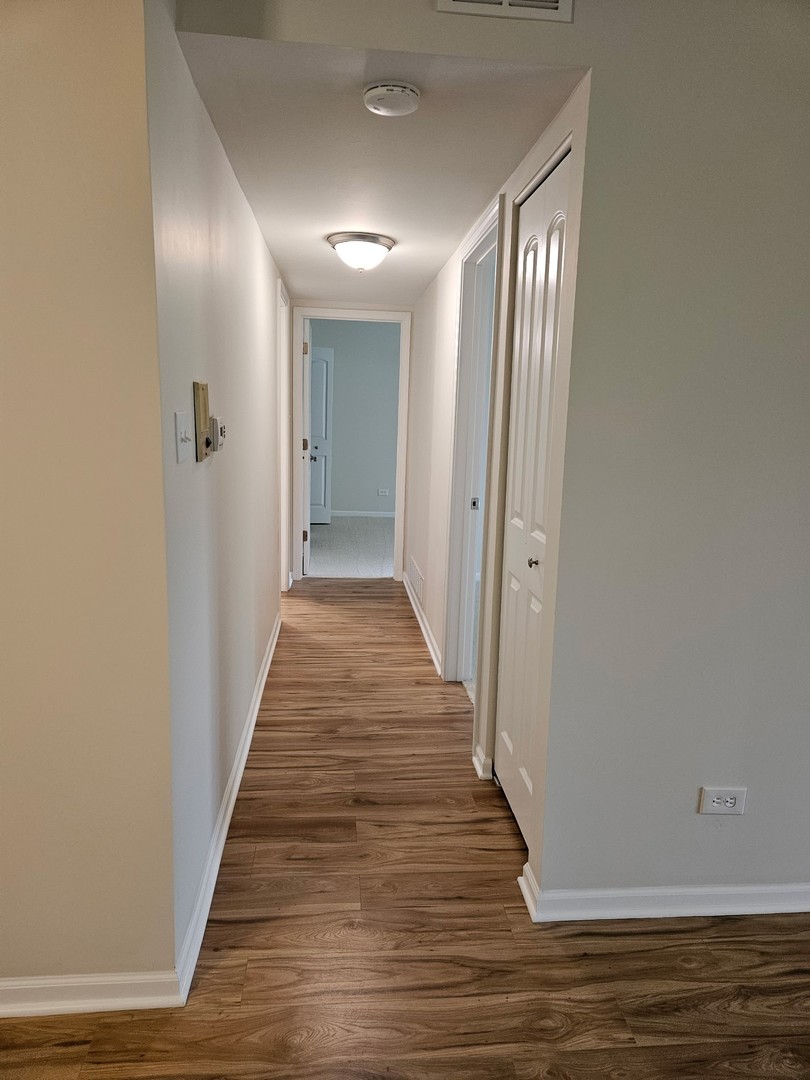 14969 South Willowcrest Drive, Unit 17 Midlothian, IL 60445 - Photo 9 of 12 a view of a hallway with wooden floor