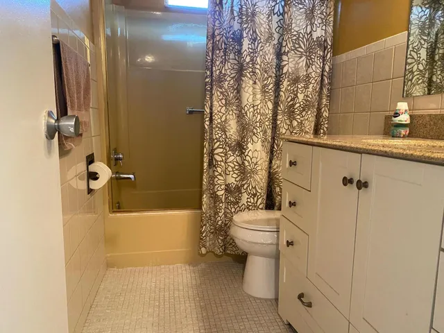 a bathroom with a toilet and shower