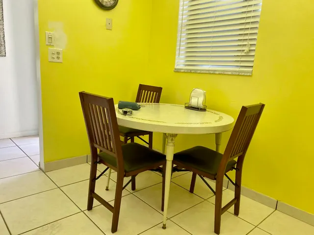 a view of a dining room with a table and chairs