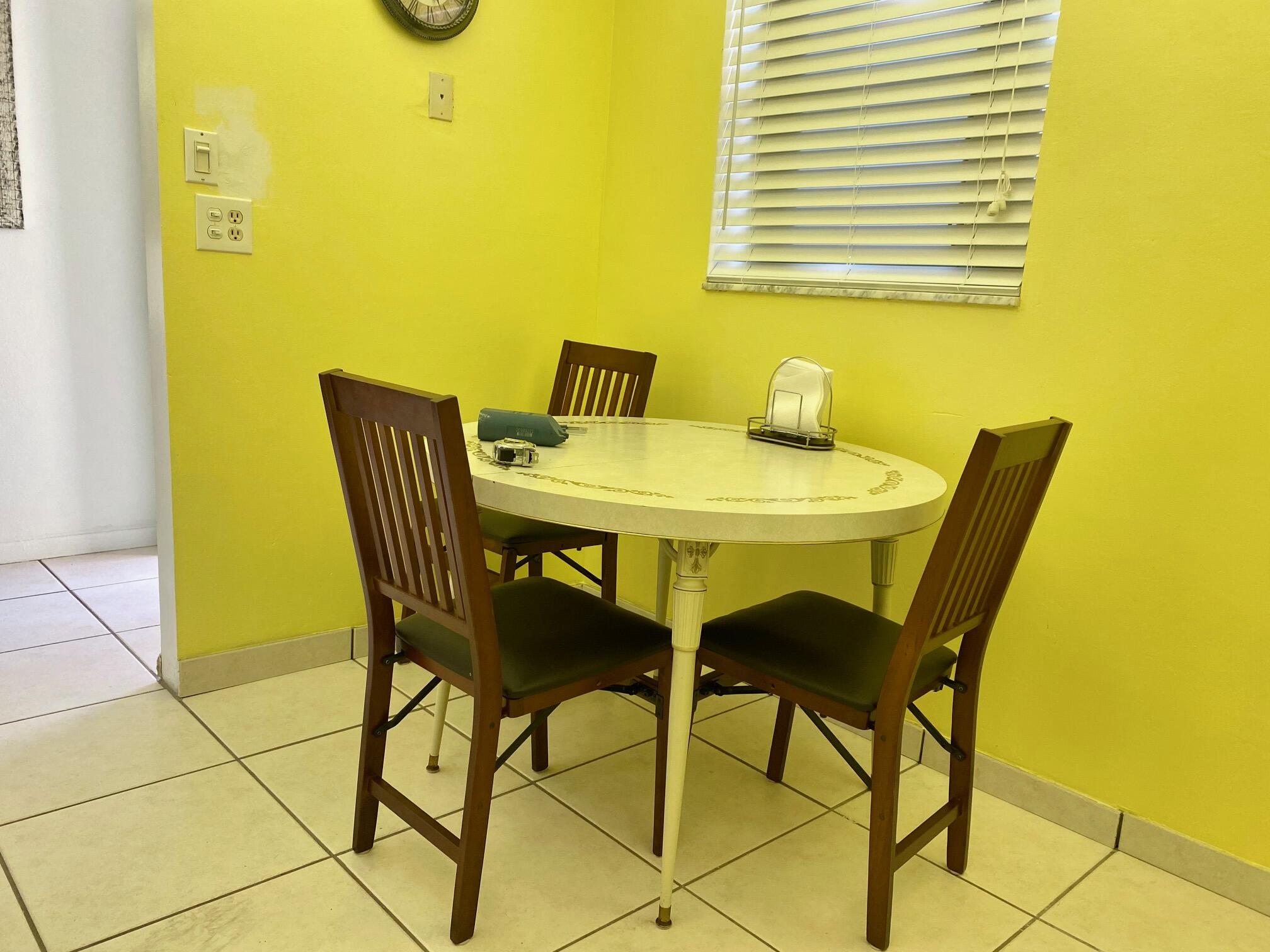 2615 Northeast 3rd Street, Unit 302 Boynton Beach, FL 33435 - Photo 5 of 14 a view of a dining room with a table and chairs