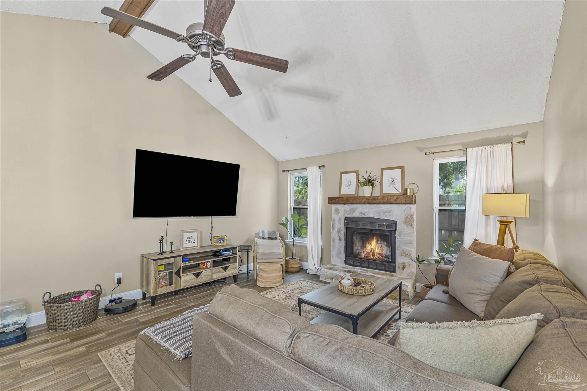 1833 Hunters Path Fort Walton Beach, FL 32547 - Photo 12 of 44 a living room with furniture a fireplace and a flat screen tv