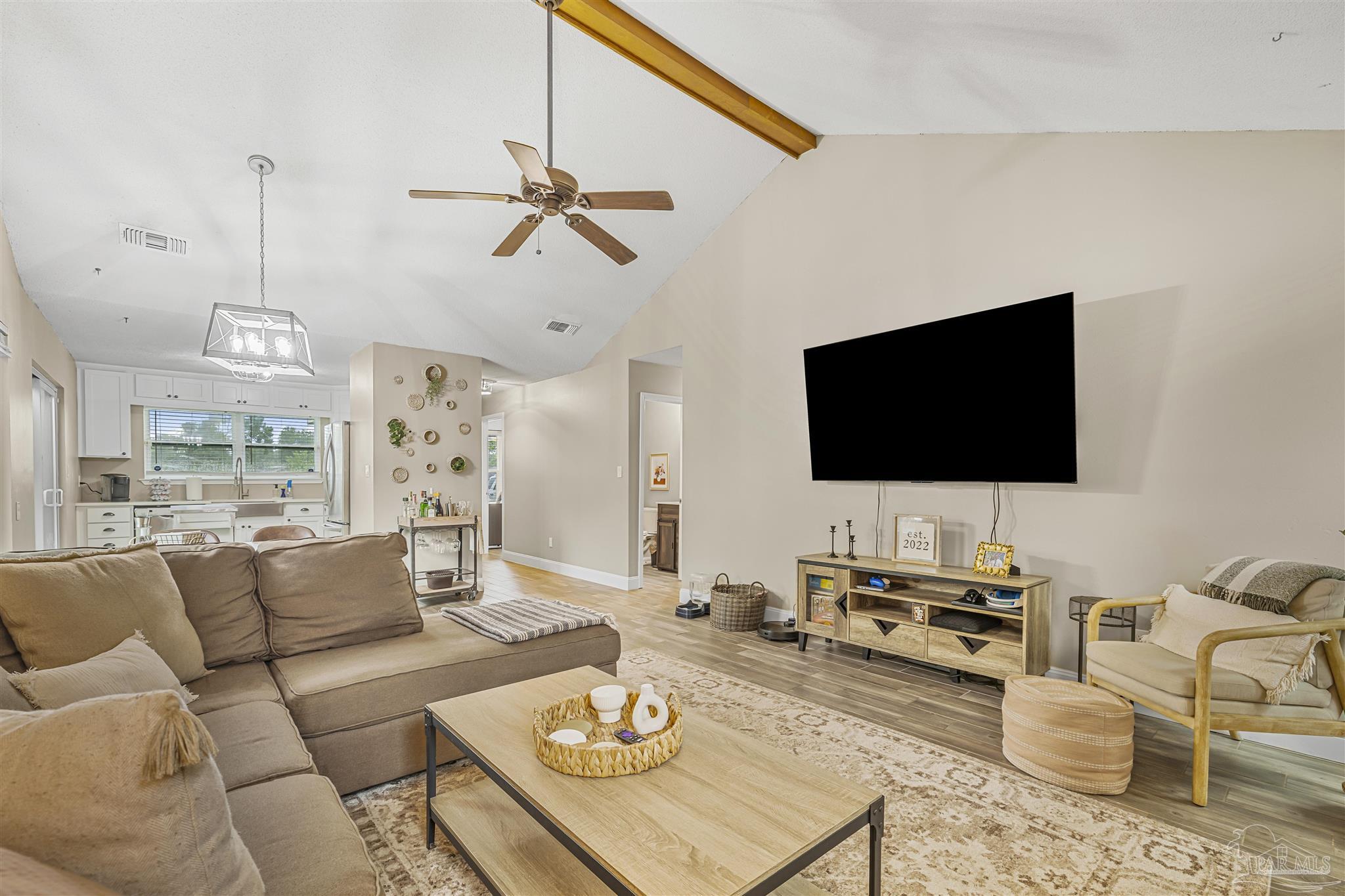 1833 Hunters Path Fort Walton Beach, FL 32547 - Photo 13 of 44 a living room with furniture a rug and a flat screen tv
