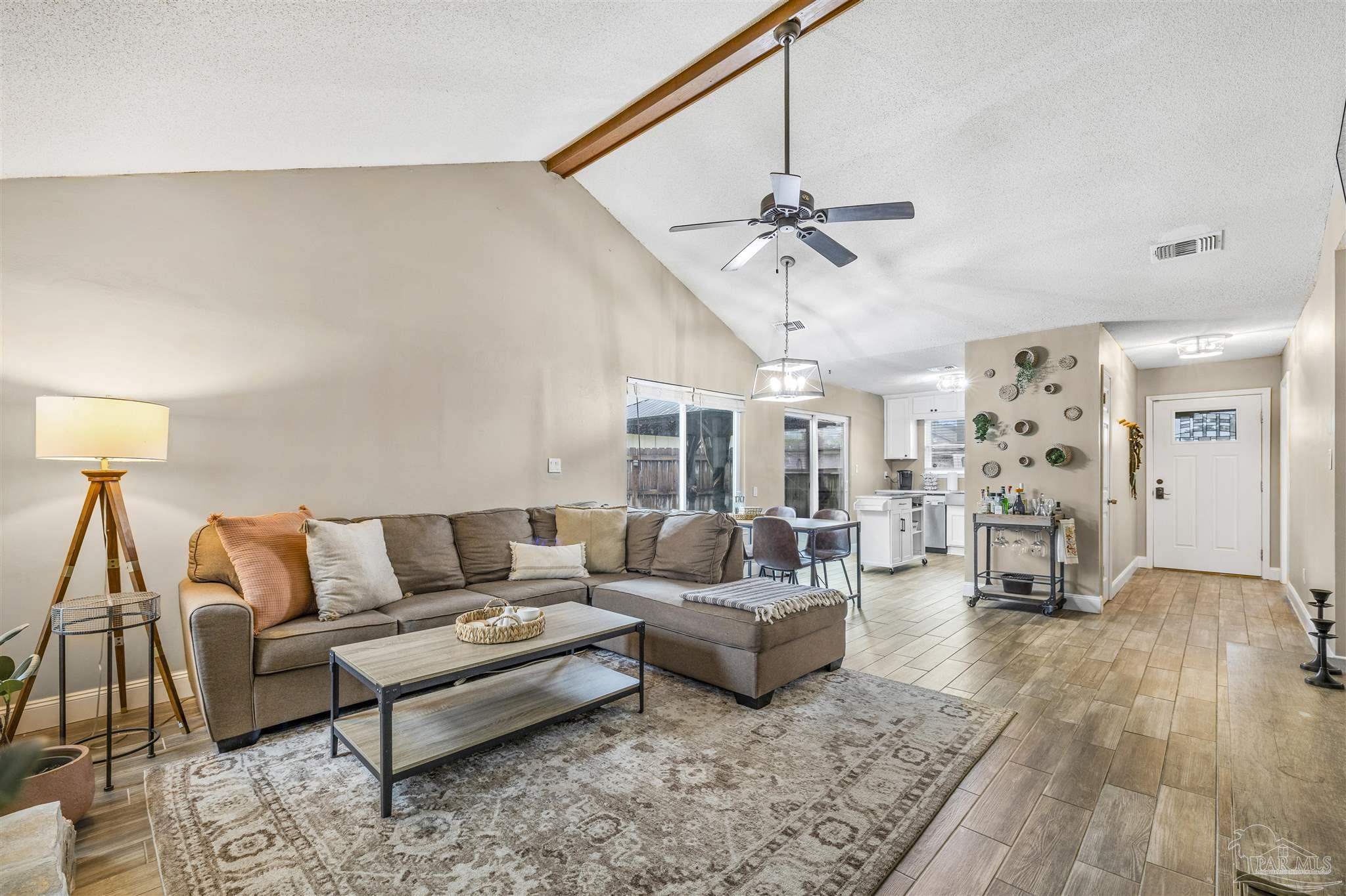 1833 Hunters Path Fort Walton Beach, FL 32547 - Photo 14 of 44 a living room with furniture and a chandelier