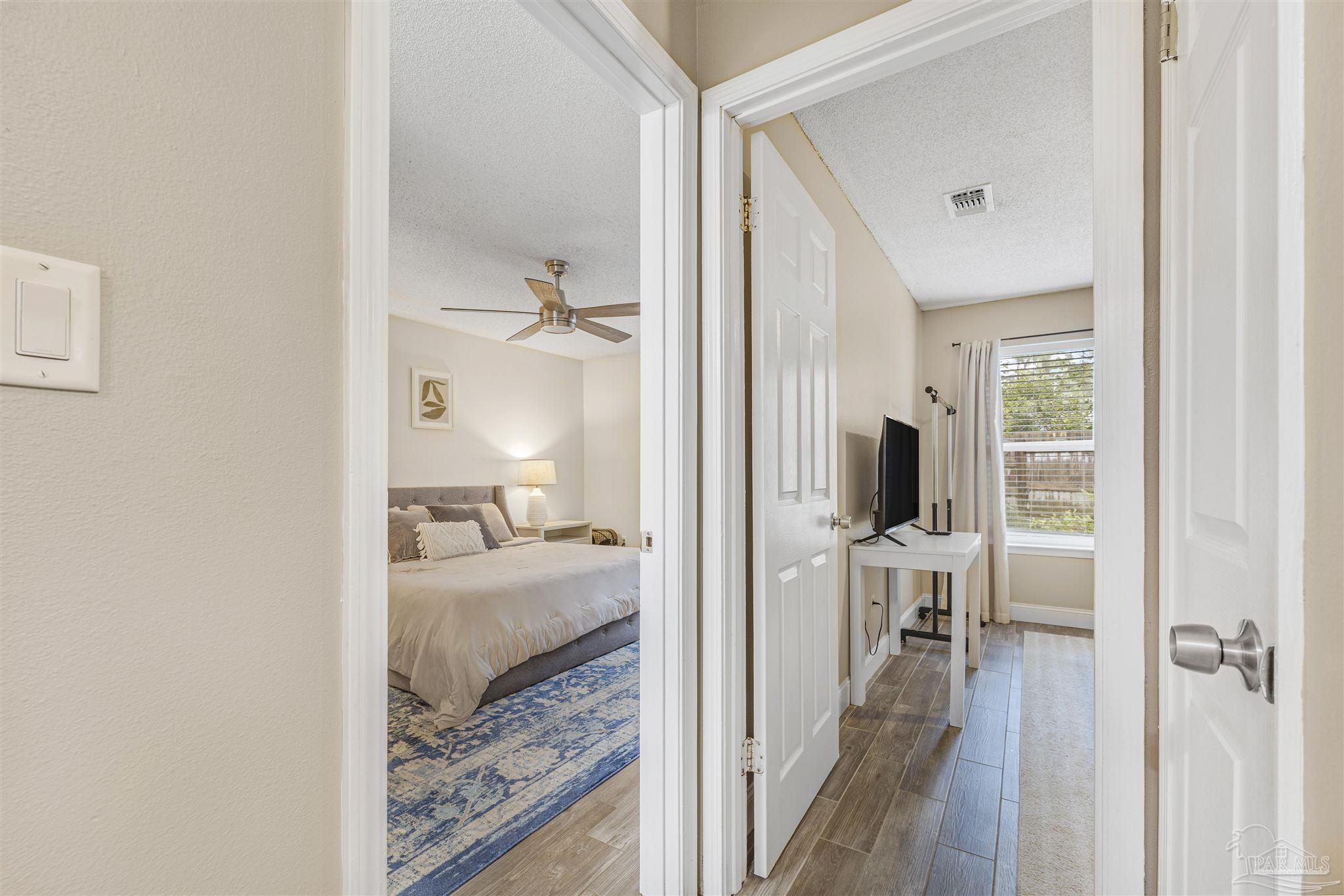 1833 Hunters Path Fort Walton Beach, FL 32547 - Photo 21 of 44 a view of a bedroom with a bed and wooden floor