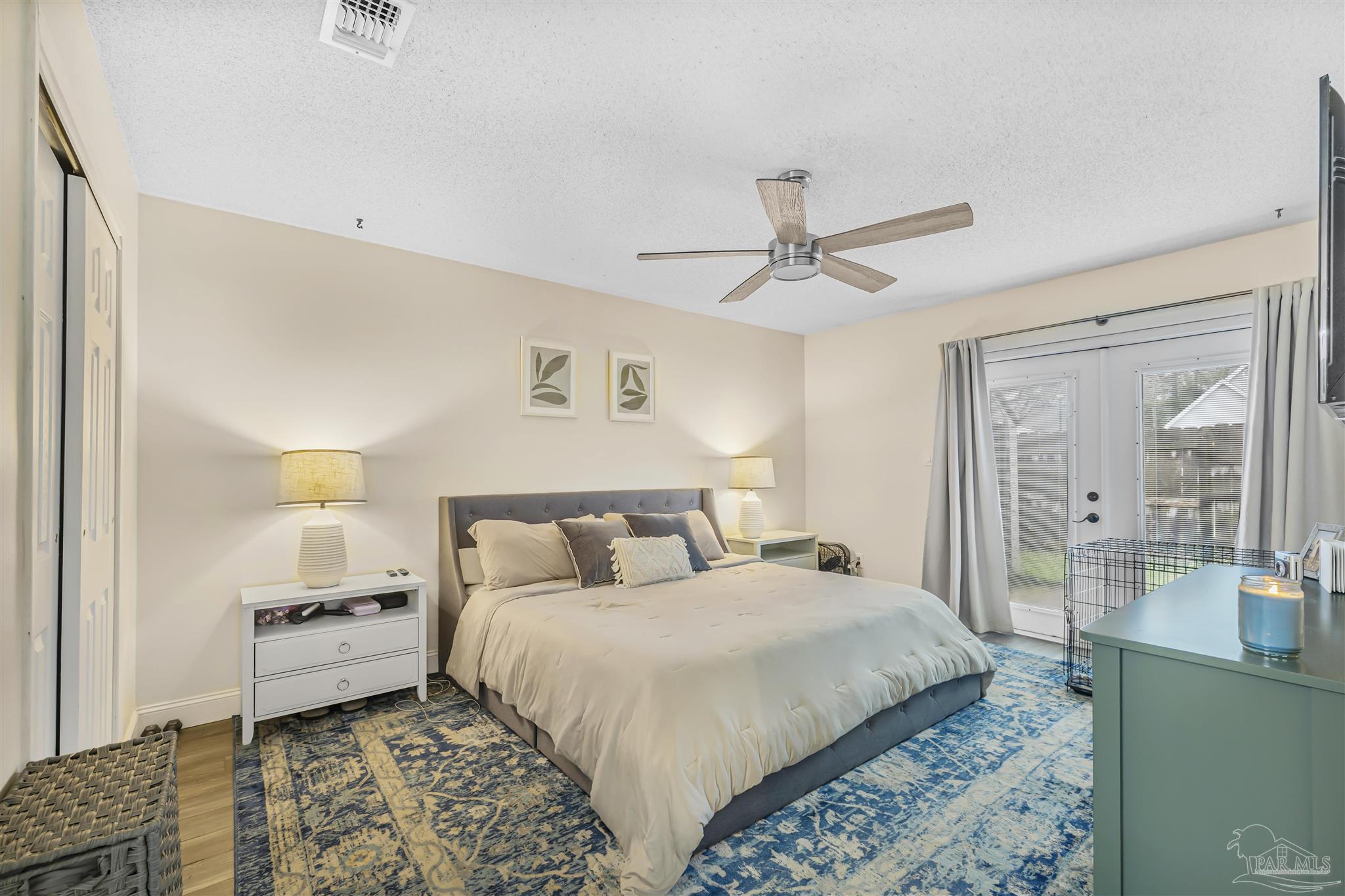 1833 Hunters Path Fort Walton Beach, FL 32547 - Photo 24 of 44 a bedroom with a large bed and a chandelier