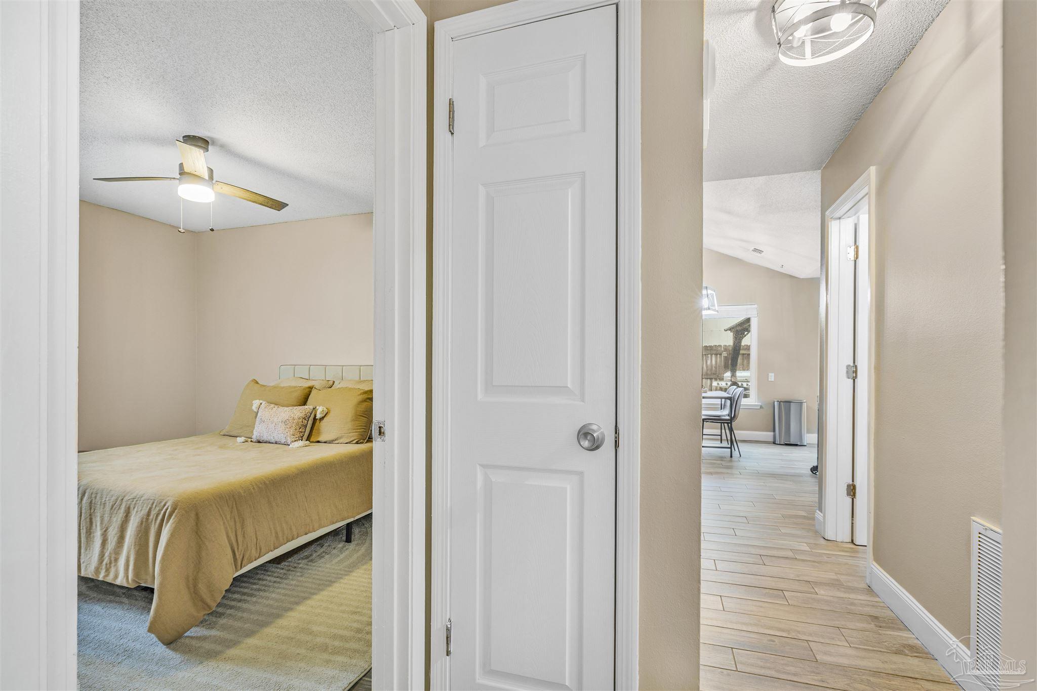 1833 Hunters Path Fort Walton Beach, FL 32547 - Photo 29 of 44 a bedroom with a bed and a chandelier