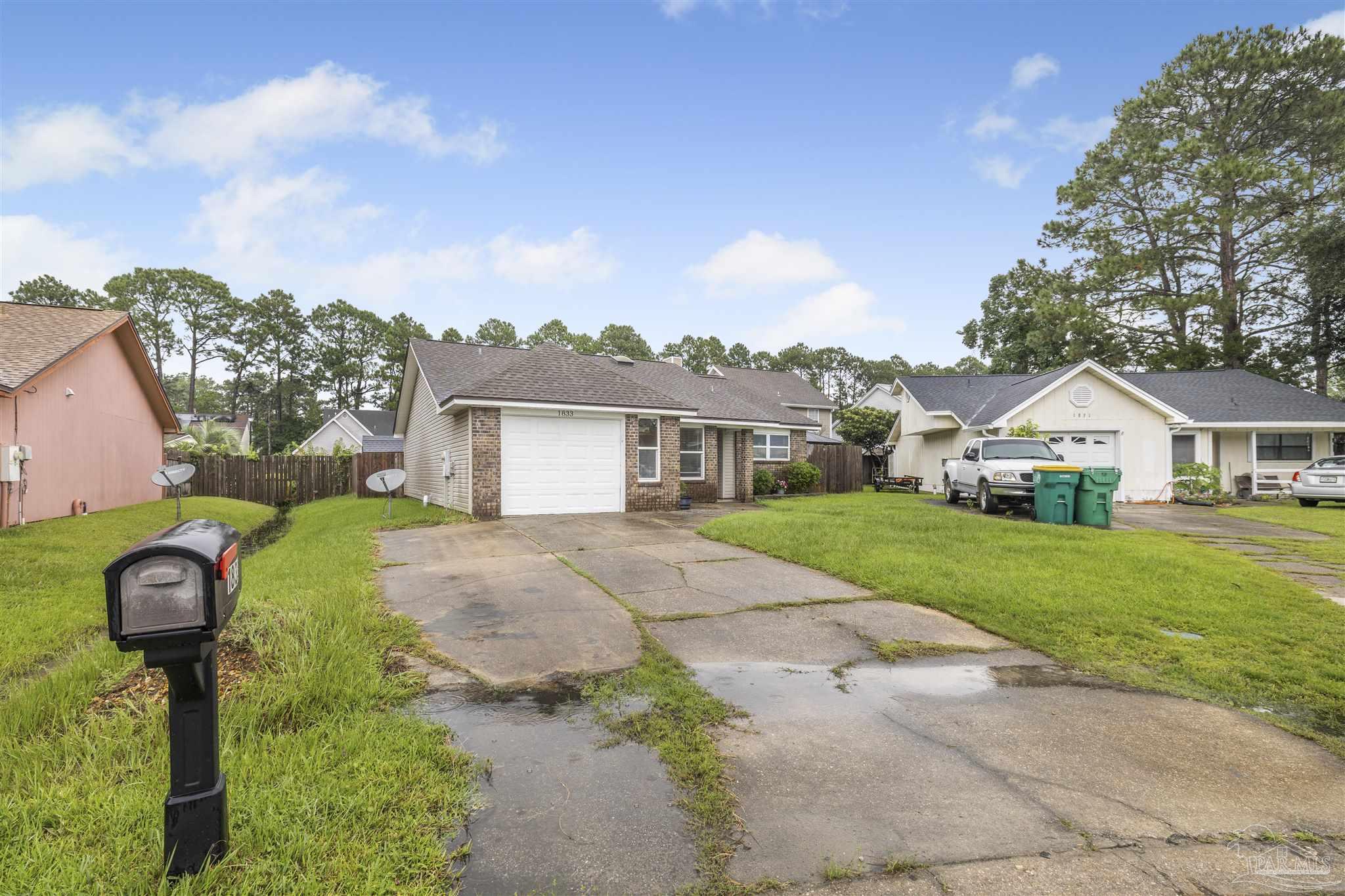 1833 Hunters Path Fort Walton Beach, FL 32547 - Photo 30 of 44 a front view of a house with a yard and garage