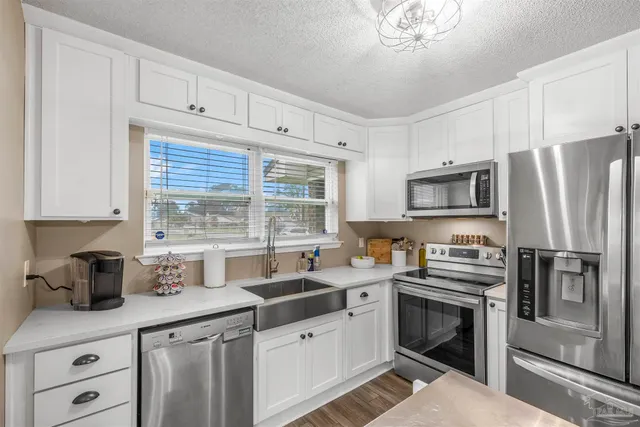 a kitchen with a sink stove and microwave