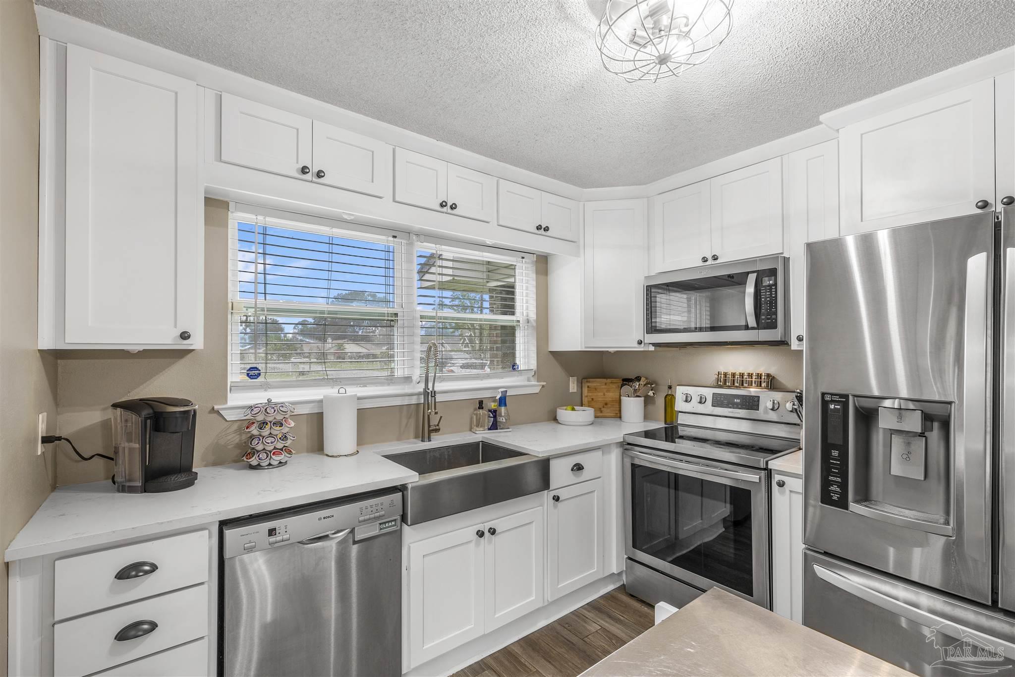 1833 Hunters Path Fort Walton Beach, FL 32547 - Photo 3 of 44 a kitchen with a sink stove and microwave