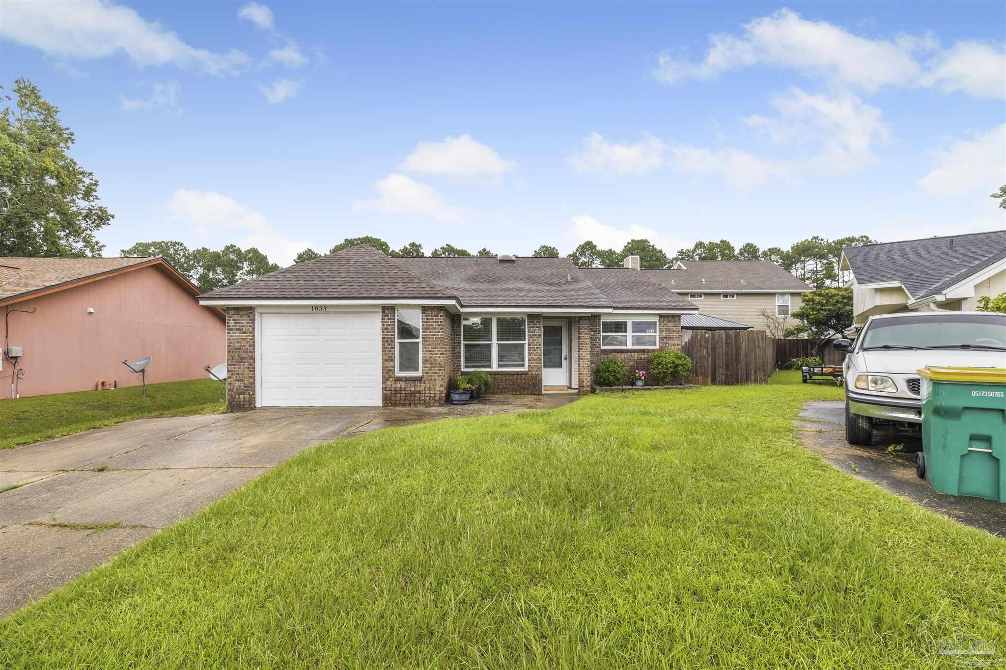 1833 Hunters Path Fort Walton Beach, FL 32547 - Photo 32 of 44 a view of a yard in front of a house with a large tree