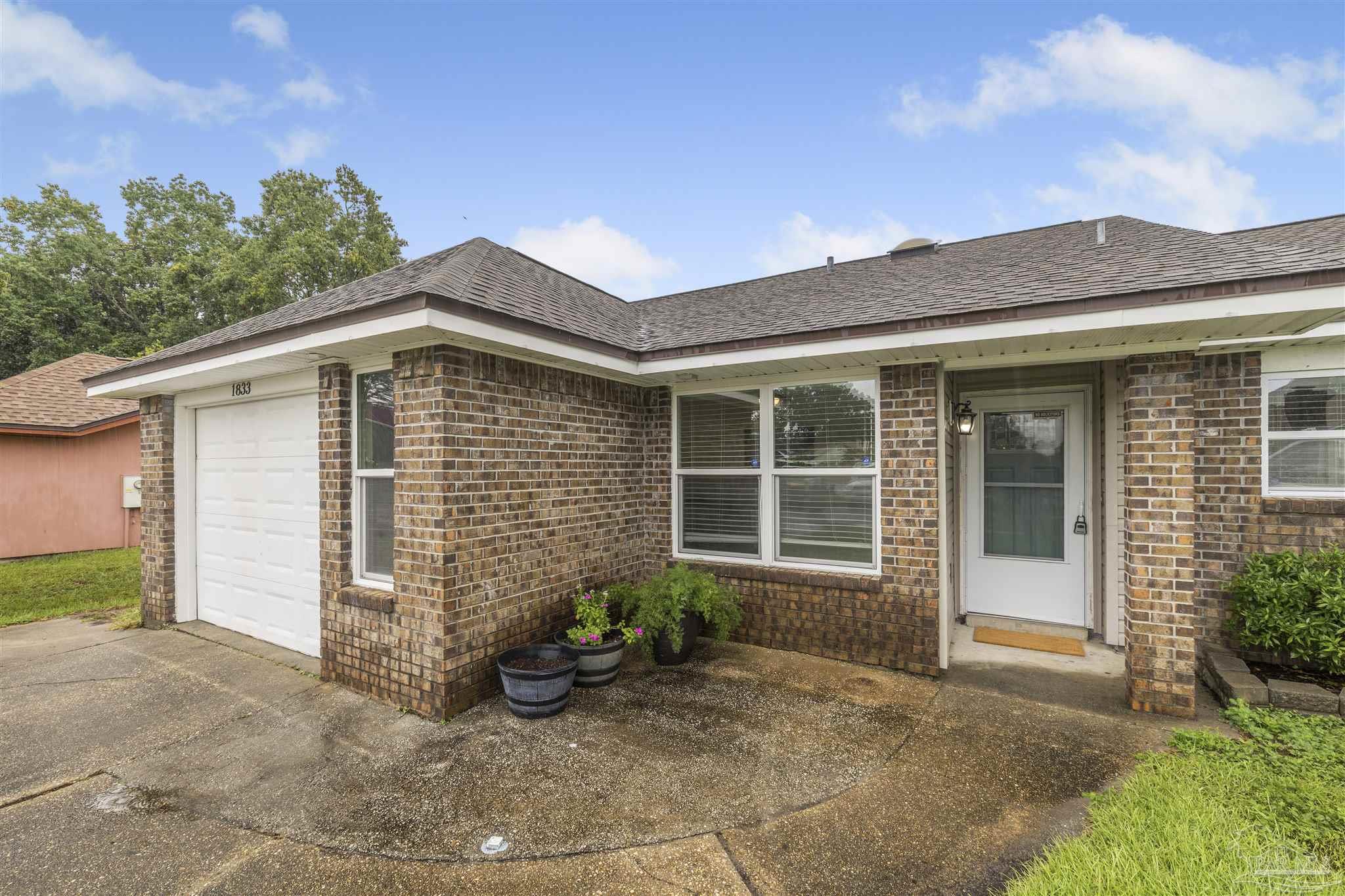 1833 Hunters Path Fort Walton Beach, FL 32547 - Photo 34 of 44 a front view of a house with garden
