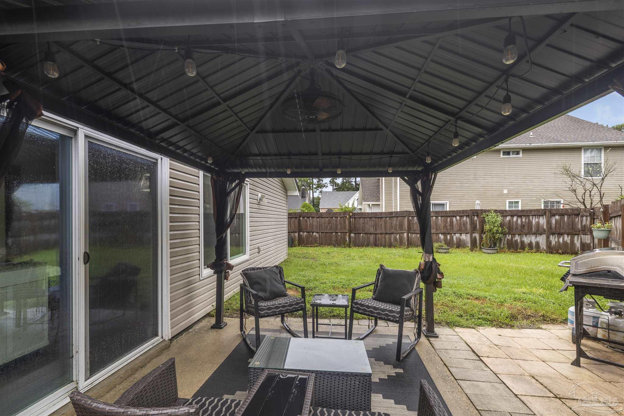 1833 Hunters Path Fort Walton Beach, FL 32547 - Photo 36 of 44 a view of chairs and table in patio with a yard