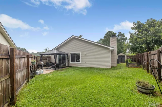 a view of a house with a yard and sitting area