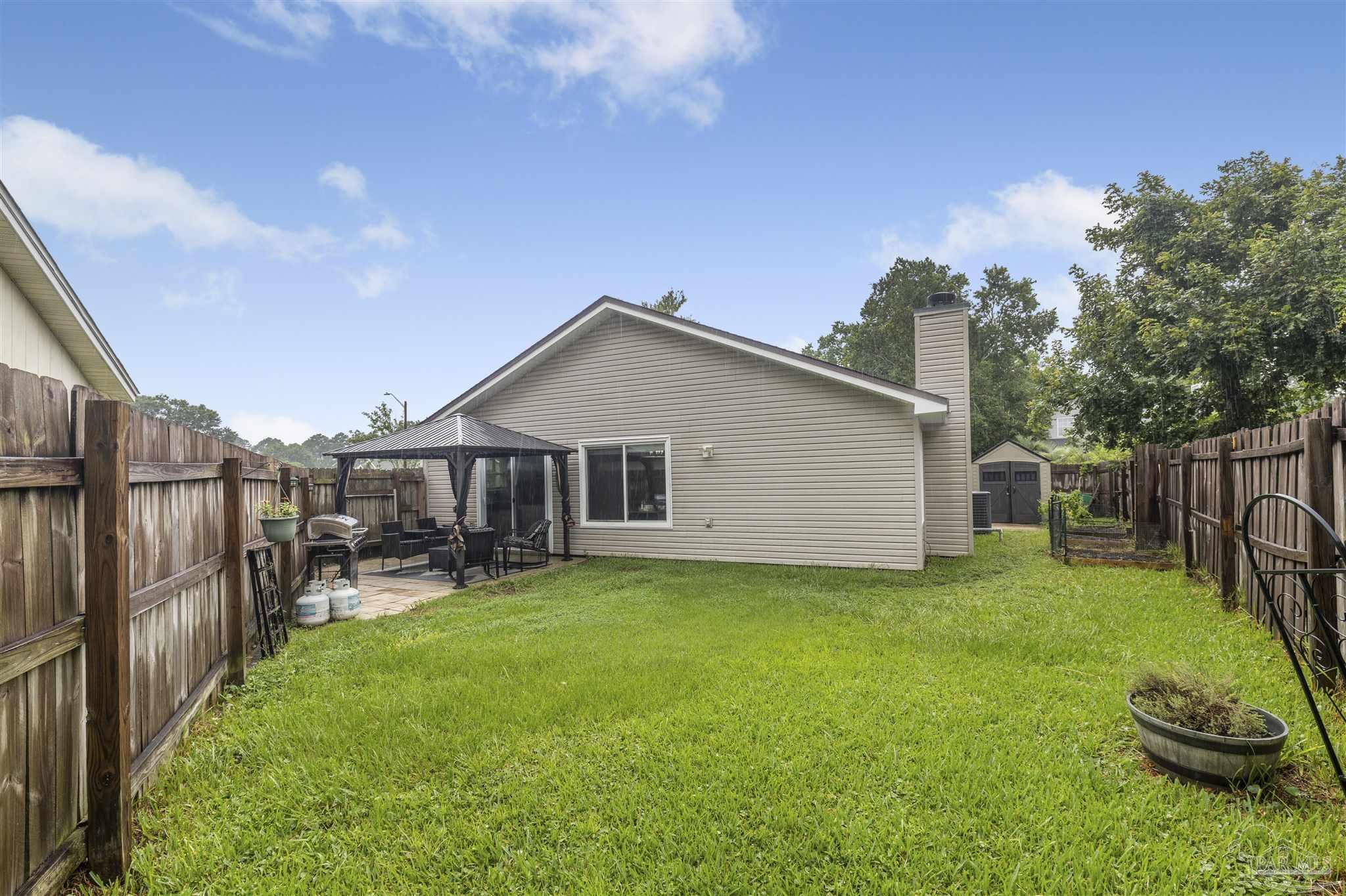1833 Hunters Path Fort Walton Beach, FL 32547 - Photo 38 of 44 a view of a backyard with table and chairs and a barbeque
