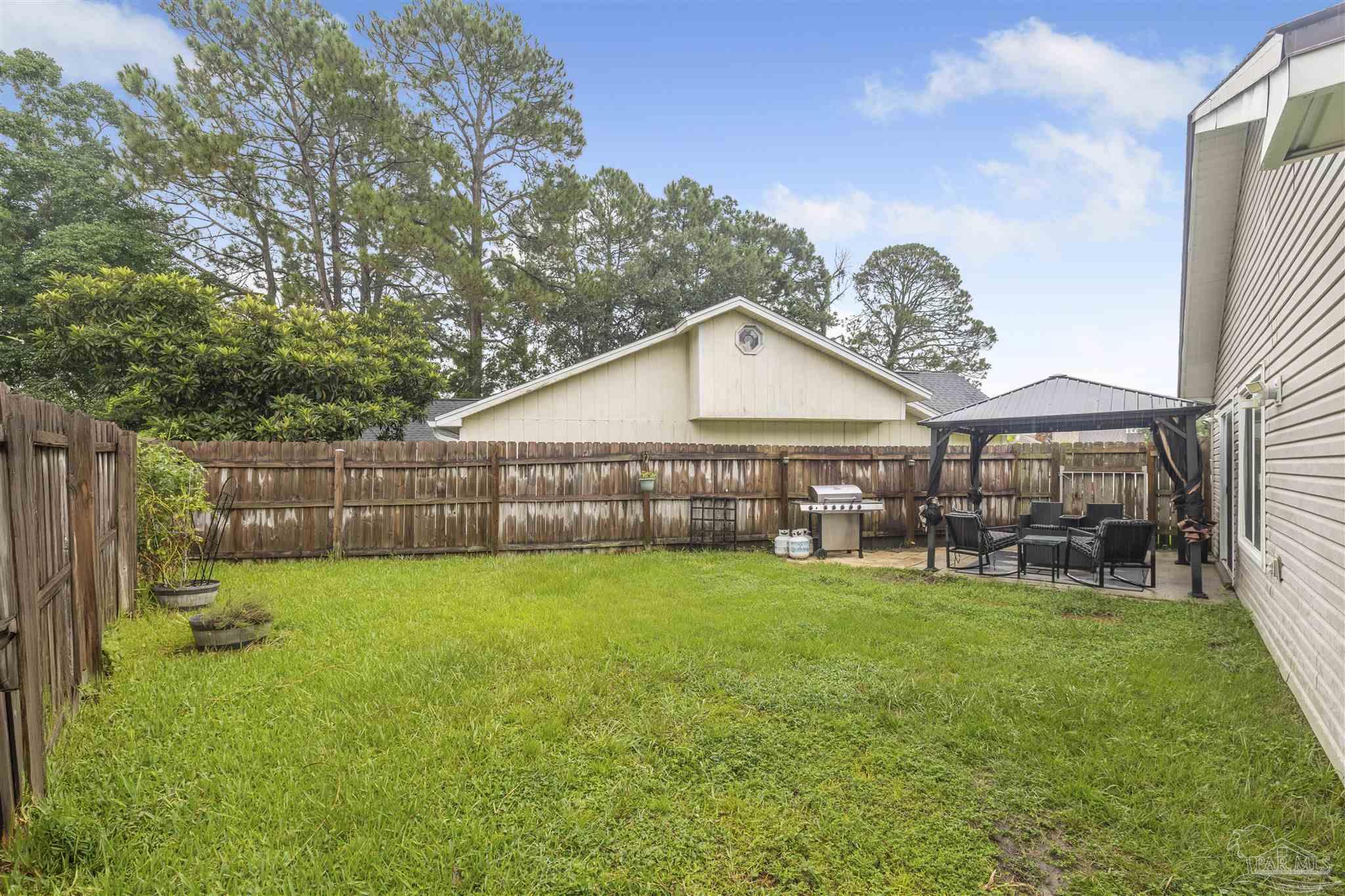 1833 Hunters Path Fort Walton Beach, FL 32547 - Photo 39 of 44 a view of a house with a yard and sitting area