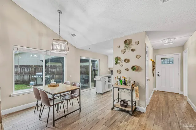 a view of a dining room with furniture window and wooden floor