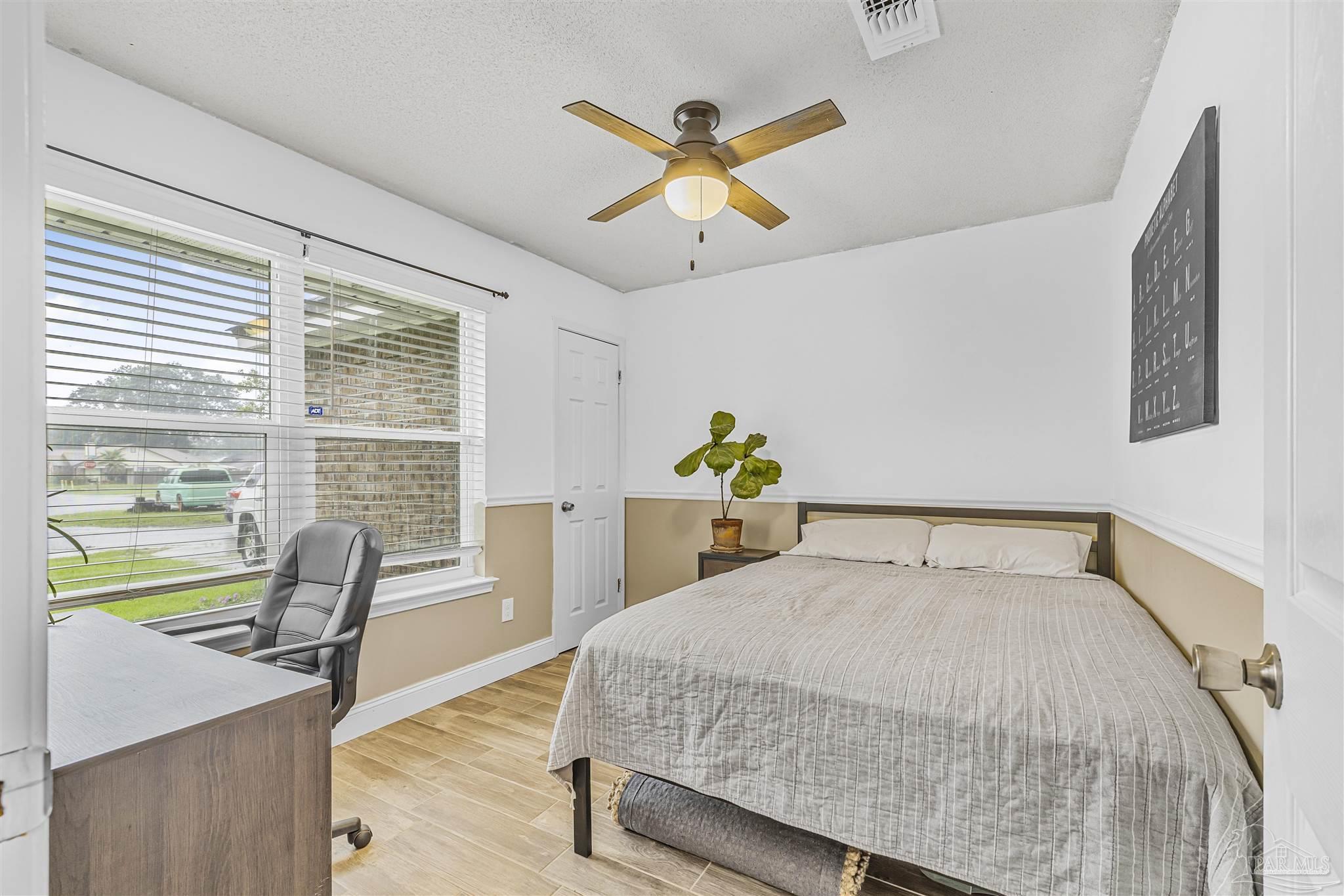 1833 Hunters Path Fort Walton Beach, FL 32547 - Photo 6 of 44 a bedroom with a bed and a large window