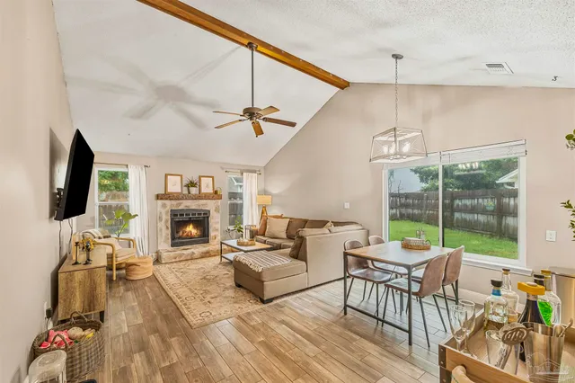 a view of a dining room with furniture a chandelier and wooden floor