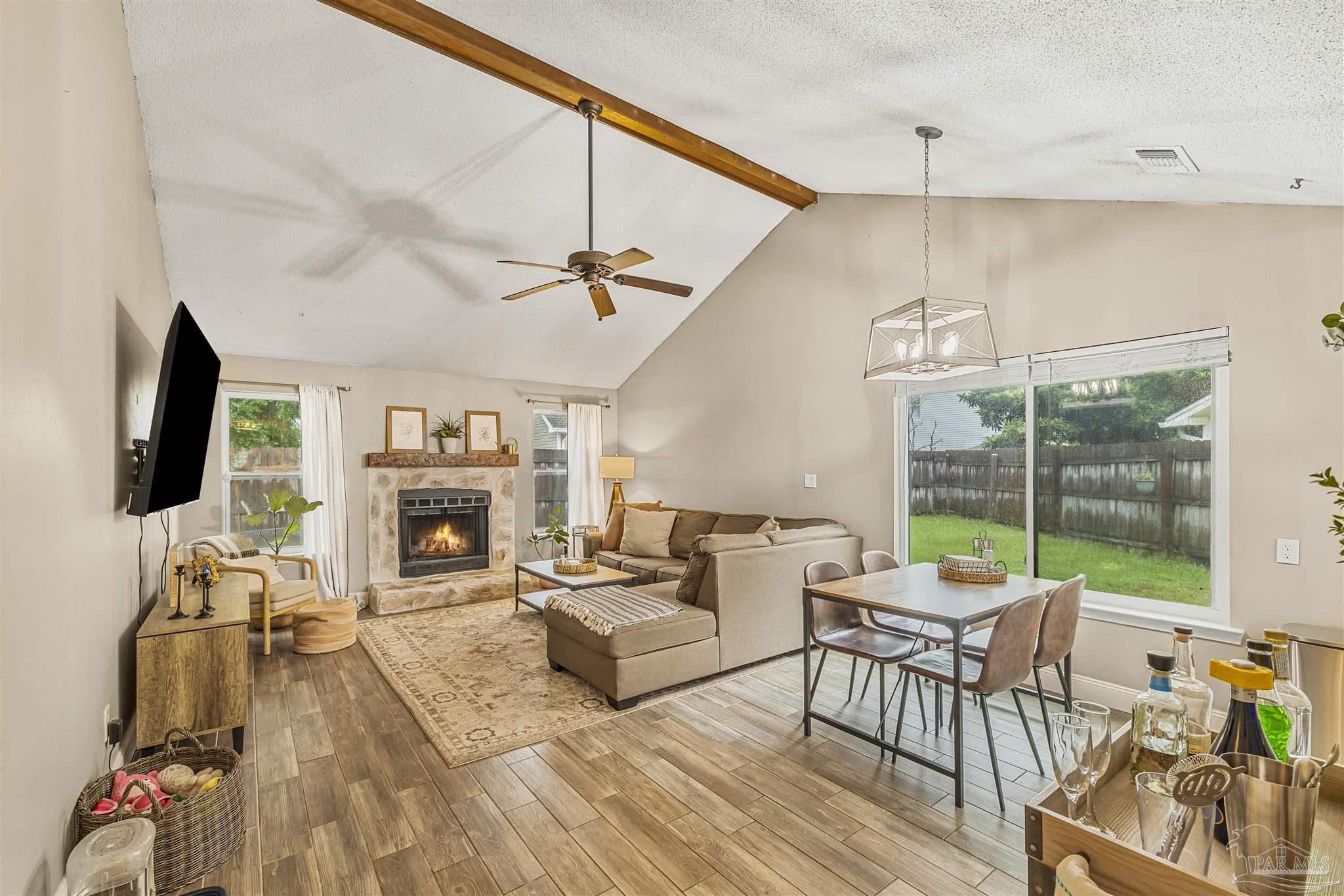 1833 Hunters Path Fort Walton Beach, FL 32547 - Photo 9 of 44 a living room with furniture a fireplace and a flat screen tv