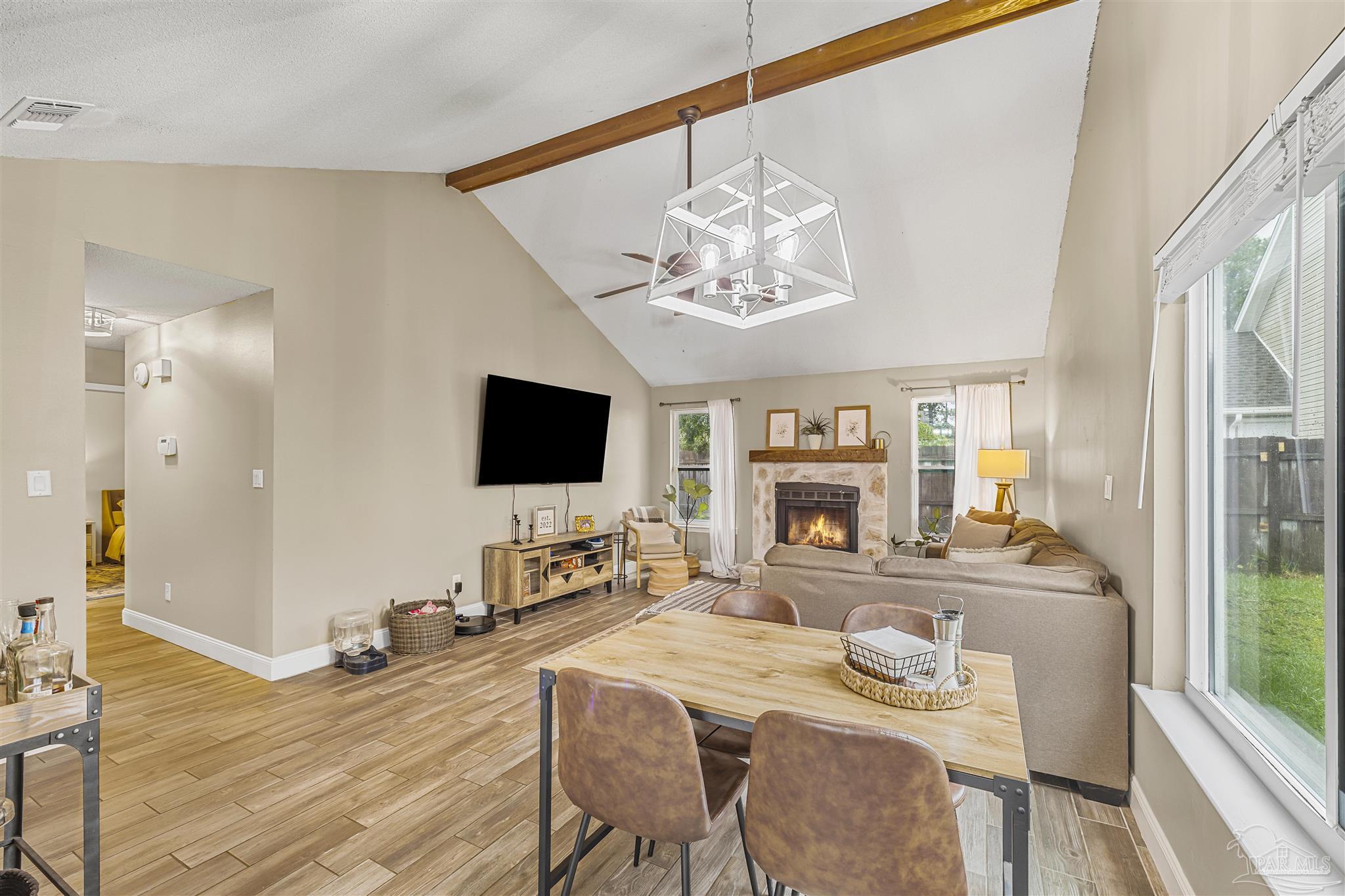 1833 Hunters Path Fort Walton Beach, FL 32547 - Photo 10 of 44 a view of a dining room with furniture a chandelier and wooden floor
