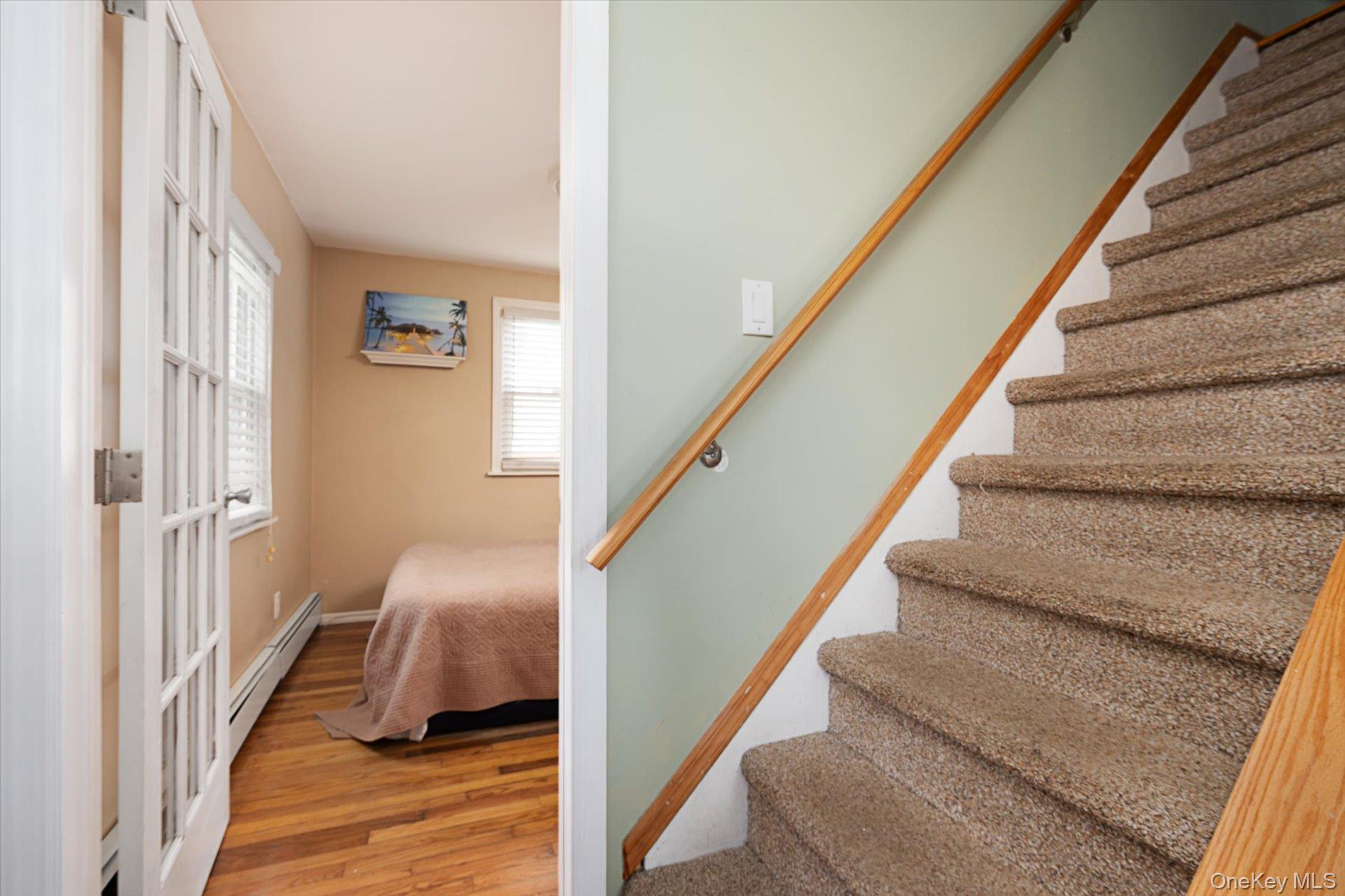 675 Little E Neck Road West Babylon, NY 11704 - Photo 11 of 20 a view of entryway and bedroom with wooden floor