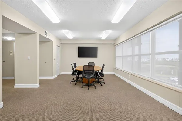 a living room with furniture kitchen view and a flat screen tv