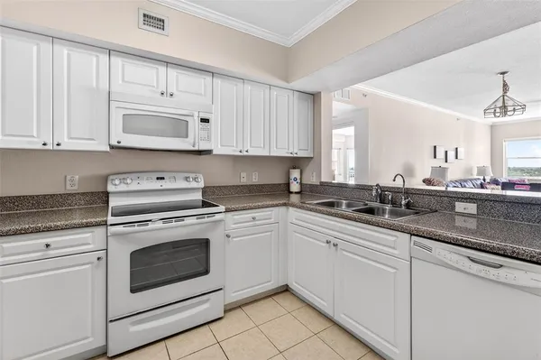 a kitchen with cabinets appliances a sink and a counter top