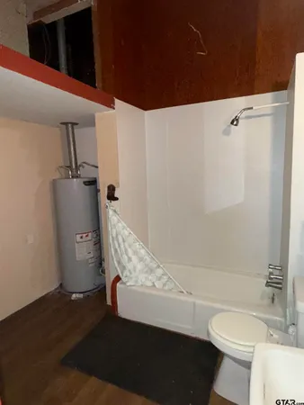 a bathroom with a toilet and a shower