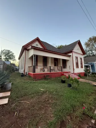 a front view of house with yard and green space
