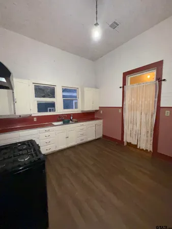 a kitchen with stainless steel appliances granite countertop a sink and a stove top oven