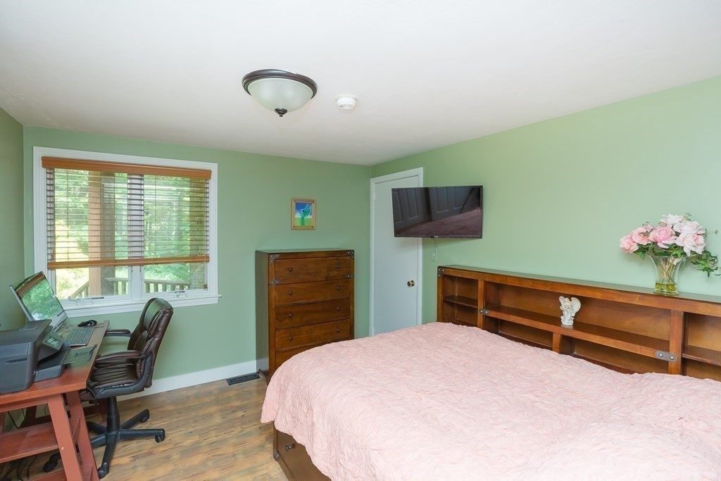 27 Algonquin Road Canton, MA 02021 - Photo 21 of 42 a bedroom with a bed and a flat screen tv