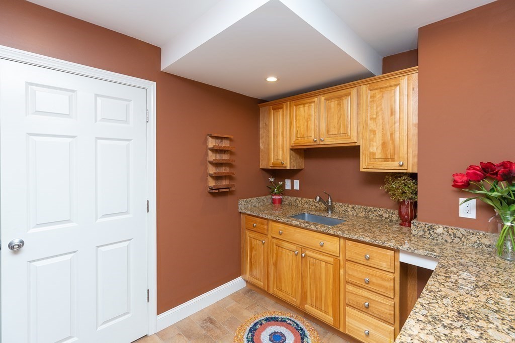 27 Algonquin Road Canton, MA 02021 - Photo 31 of 42 a kitchen with granite countertop cabinets stainless steel appliances a sink and a window