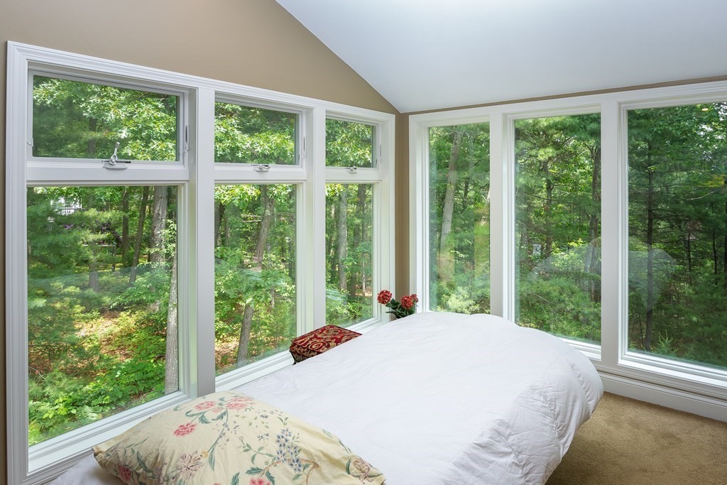 27 Algonquin Road Canton, MA 02021 - Photo 37 of 42 a bed sitting in a bedroom next to a window