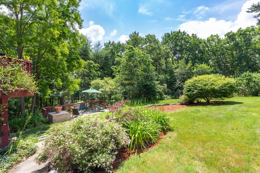 27 Algonquin Road Canton, MA 02021 - Photo 6 of 42 a backyard of a house with a yard and outdoor seating