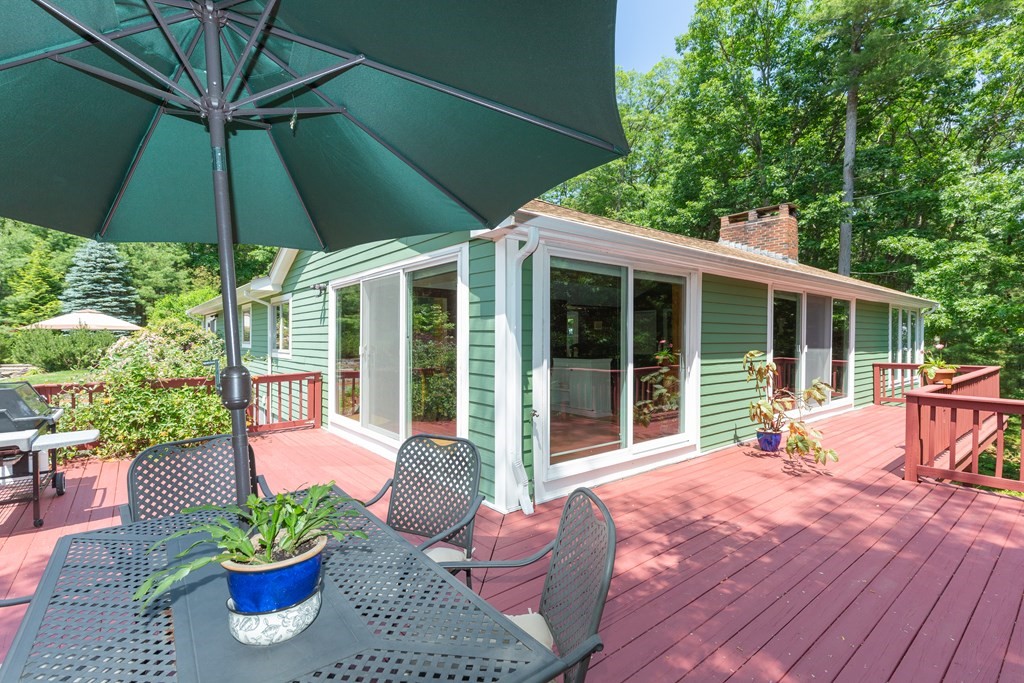 27 Algonquin Road Canton, MA 02021 - Photo 8 of 42 a patio with a table and chairs under an umbrella