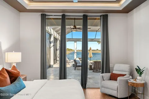 a living room with furniture a rug and a large window