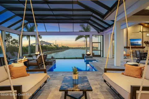 a living room with furniture a ceiling fan and a window