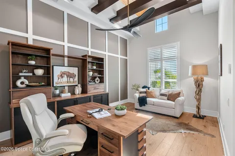 a living room with furniture a rug and a large window