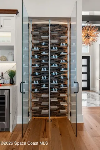 a bedroom with furniture and a potted plant on a dresser