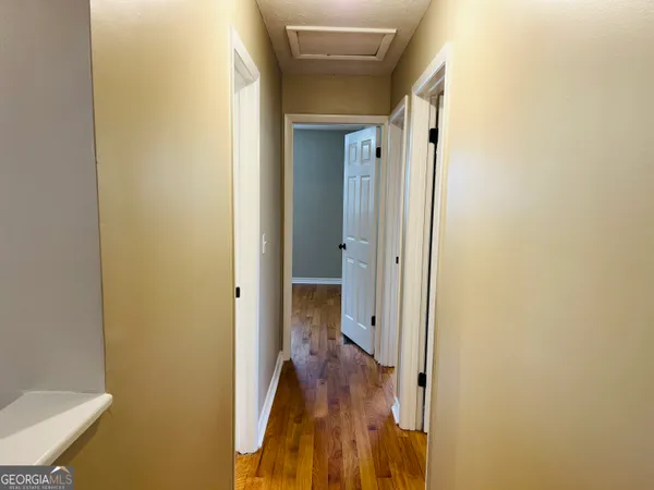 a view of a bathroom from a corridor