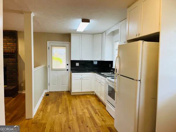 a white refrigerator freezer sitting in a kitchen