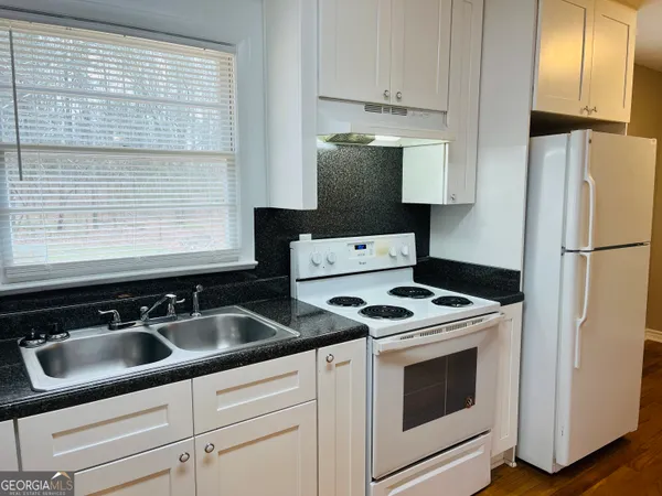 a kitchen with appliances cabinets and a sink