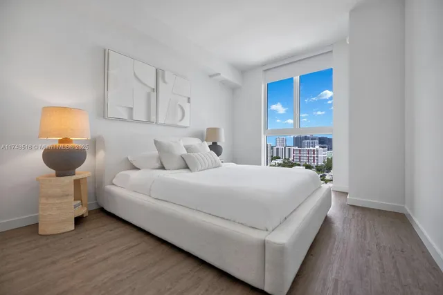 a bedroom with a bed and a potted plant