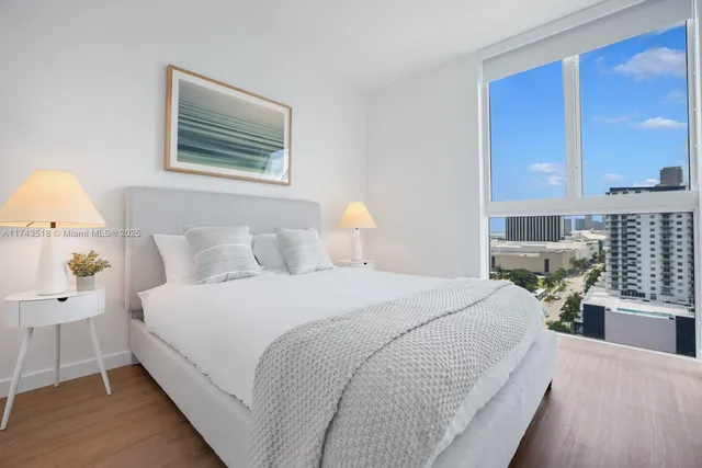 a dining room with furniture and a floor to ceiling window