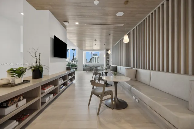 a large kitchen with a table and chairs